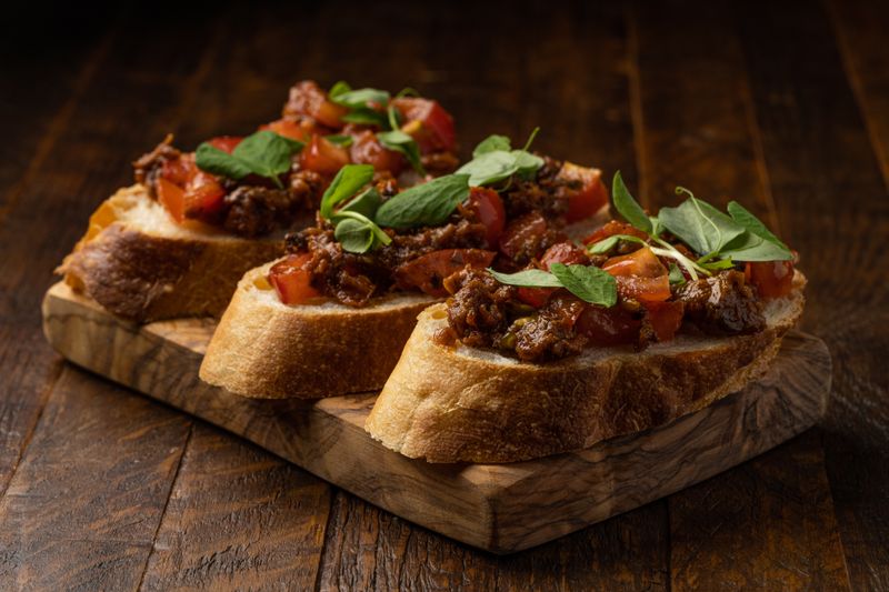 Bruschetta topped with fresh tomatoes, basil and garlic